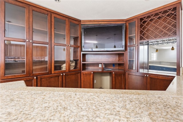 kitchen featuring a textured ceiling and light stone counters