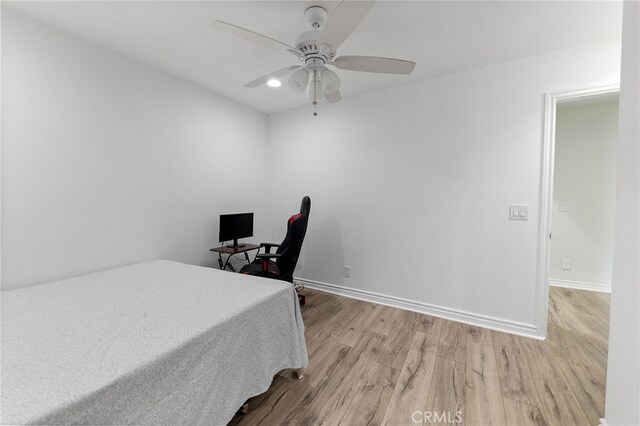 bedroom featuring light hardwood / wood-style flooring and ceiling fan