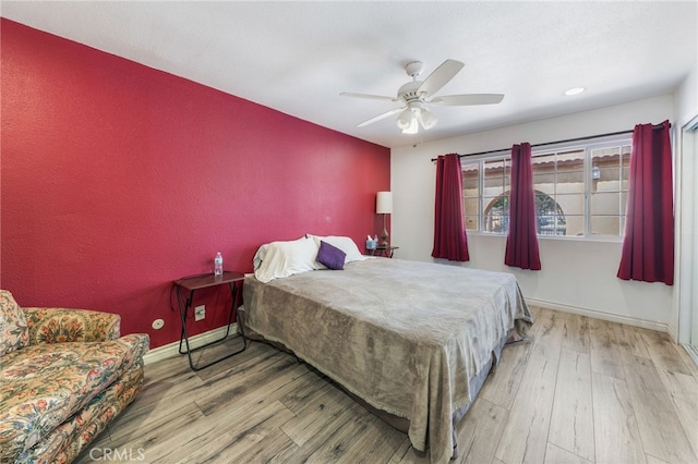 bedroom with wood-type flooring and ceiling fan