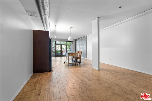 interior space featuring french doors and light hardwood / wood-style floors