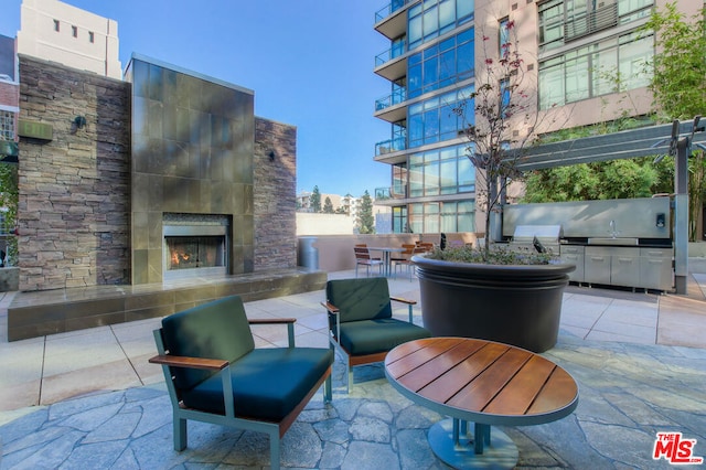 view of patio / terrace with sink and a tile fireplace