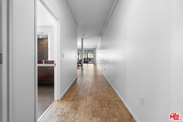 hall featuring sink and light wood-type flooring