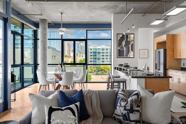 kitchen with ceiling fan, expansive windows, decorative light fixtures, and high end fridge