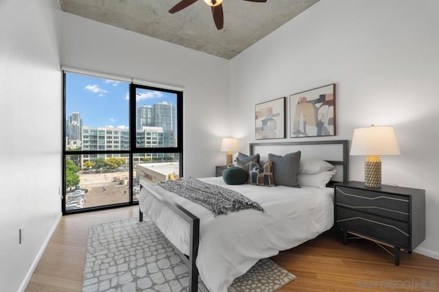 bedroom with ceiling fan and wood-type flooring