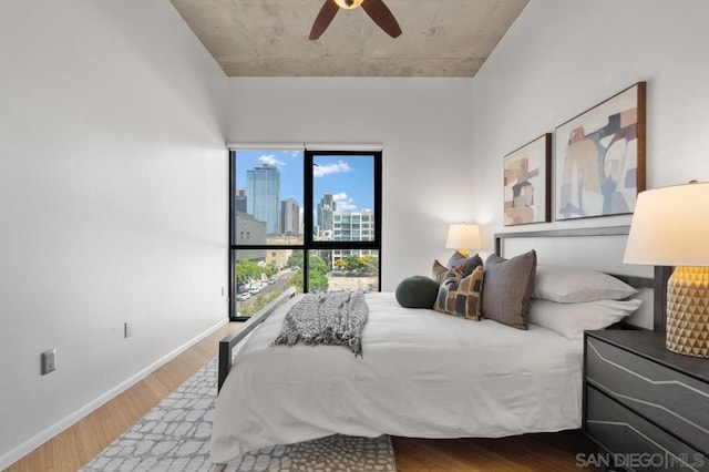 bedroom with ceiling fan and hardwood / wood-style floors