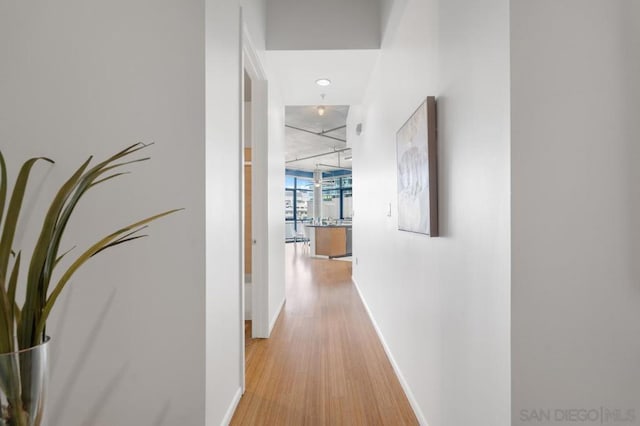 corridor with light hardwood / wood-style floors