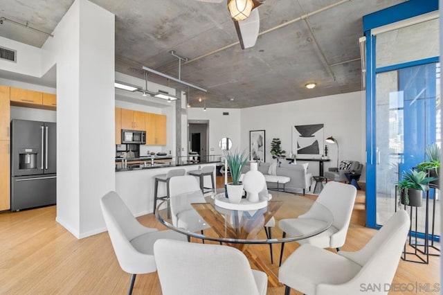 dining space with light hardwood / wood-style floors