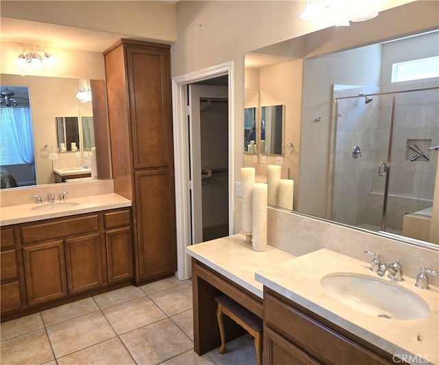 bathroom with vanity, ceiling fan, tile patterned floors, and a shower with shower door