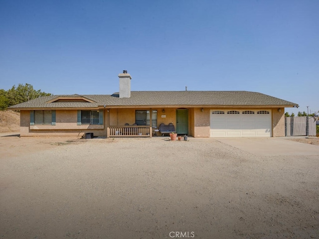 single story home with a garage and a porch