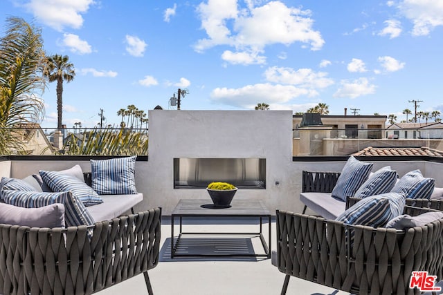 view of patio featuring a balcony and an outdoor hangout area