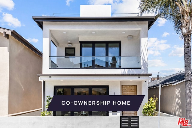 view of front of house with a balcony