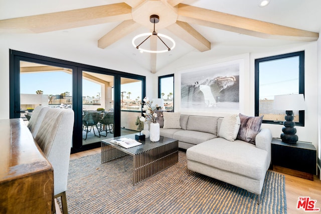 living room with wood-type flooring, vaulted ceiling with beams, and a healthy amount of sunlight