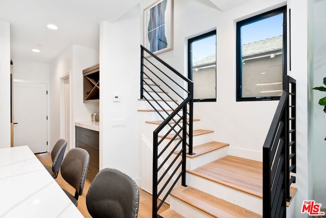 stairway featuring hardwood / wood-style floors