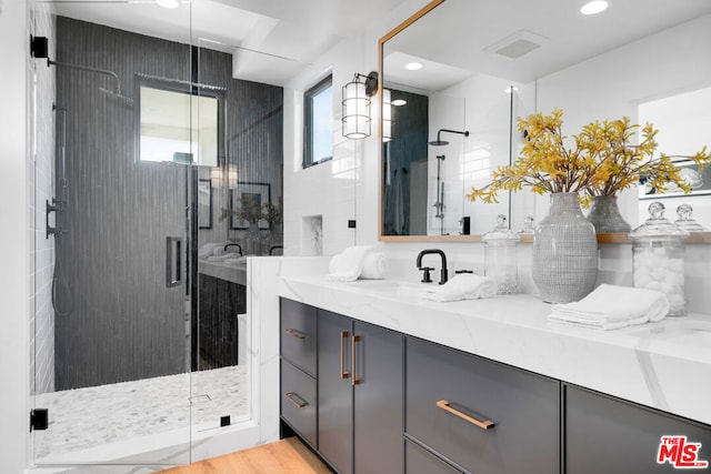 bathroom with walk in shower, a healthy amount of sunlight, vanity, and hardwood / wood-style flooring