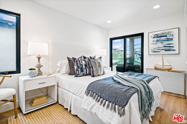 bedroom with light hardwood / wood-style flooring and access to exterior