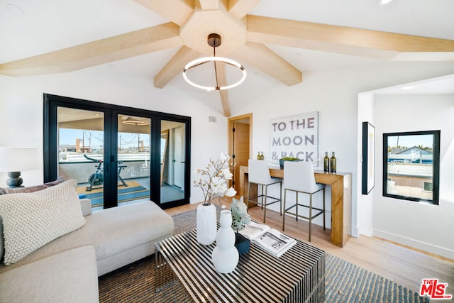 living room featuring lofted ceiling with beams, hardwood / wood-style flooring, and french doors