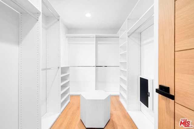 spacious closet featuring hardwood / wood-style flooring