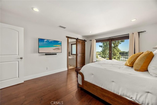 bedroom featuring access to outside, ensuite bath, dark hardwood / wood-style flooring, and a barn door