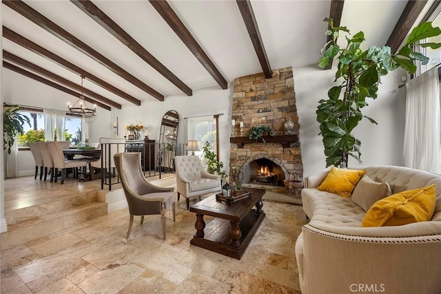 living room with lofted ceiling with beams, a fireplace, and an inviting chandelier