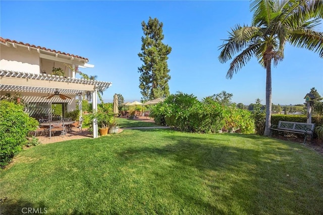 view of yard with a pergola, ceiling fan, and a patio