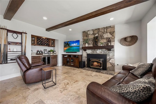 living room featuring bar, a fireplace, beamed ceiling, and wine cooler