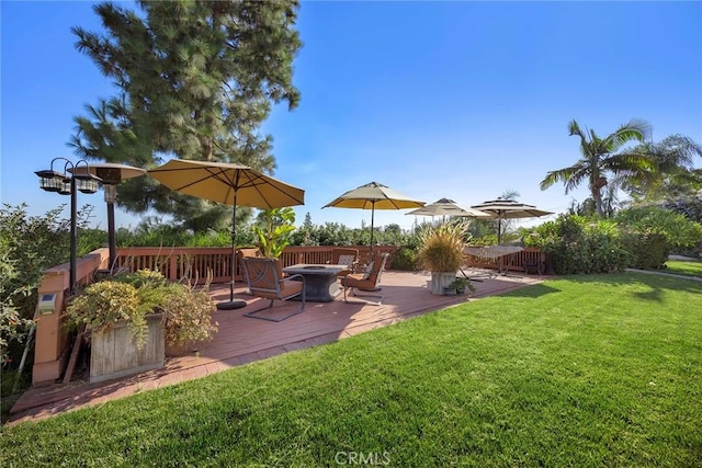 view of yard with a fire pit and a deck