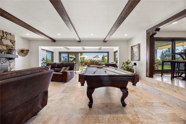 playroom featuring a fireplace, beam ceiling, a healthy amount of sunlight, and pool table