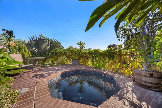 view of pool with a deck and a jacuzzi