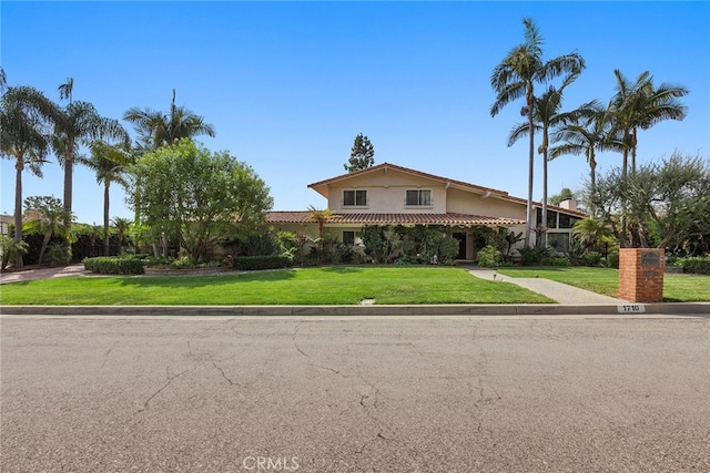 mediterranean / spanish-style house featuring a front lawn