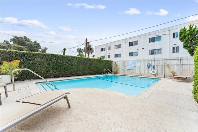 view of swimming pool with a patio