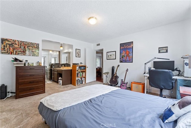 bedroom with light carpet and a textured ceiling