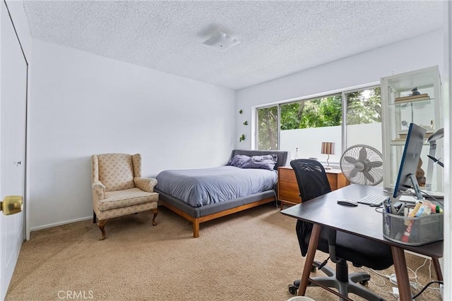 carpeted bedroom featuring a textured ceiling