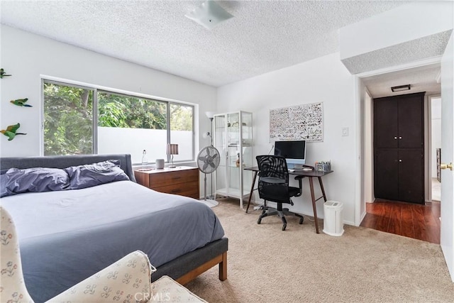 bedroom featuring carpet floors and a textured ceiling