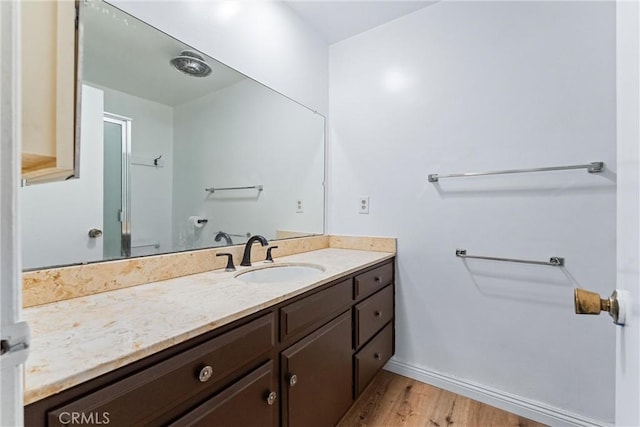 bathroom featuring wood-type flooring and vanity