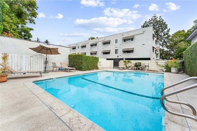 view of swimming pool with central AC unit and a patio