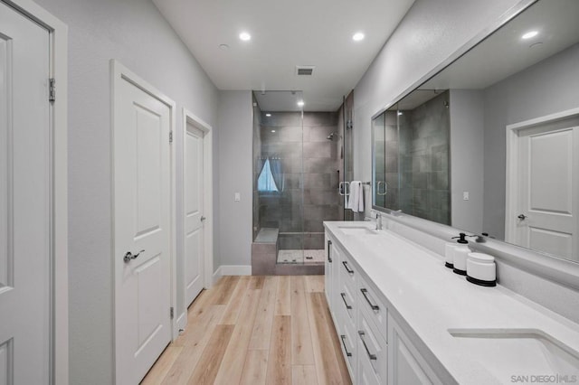 bathroom featuring vanity, wood-type flooring, and an enclosed shower