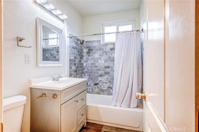 full bathroom with shower / bath combination with curtain, hardwood / wood-style flooring, vanity, and toilet