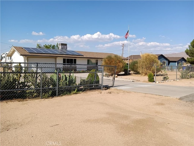 exterior space featuring a garage and solar panels