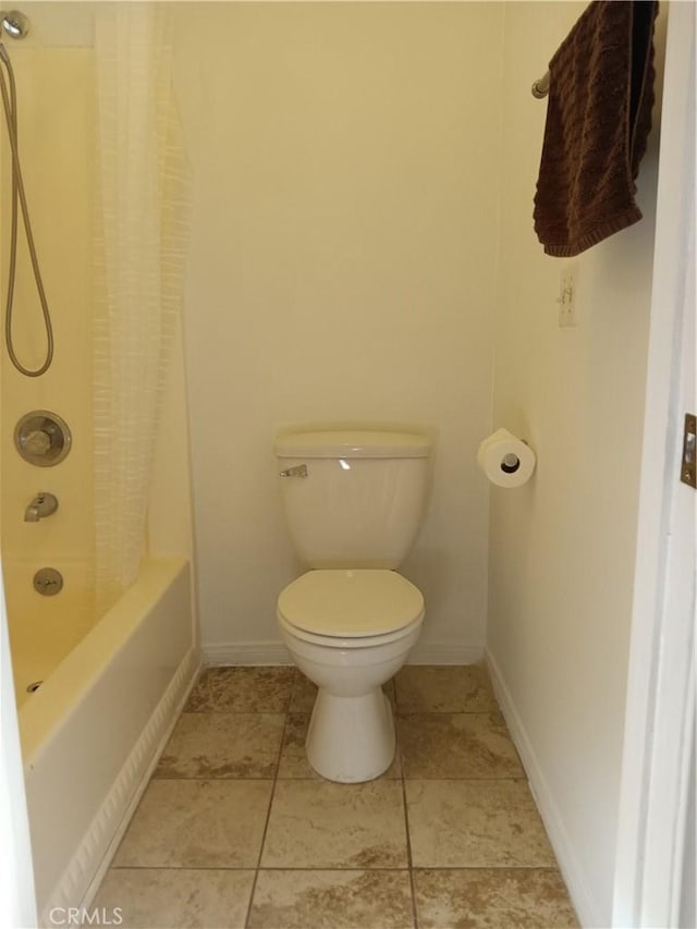 bathroom with toilet and shower / tub combo