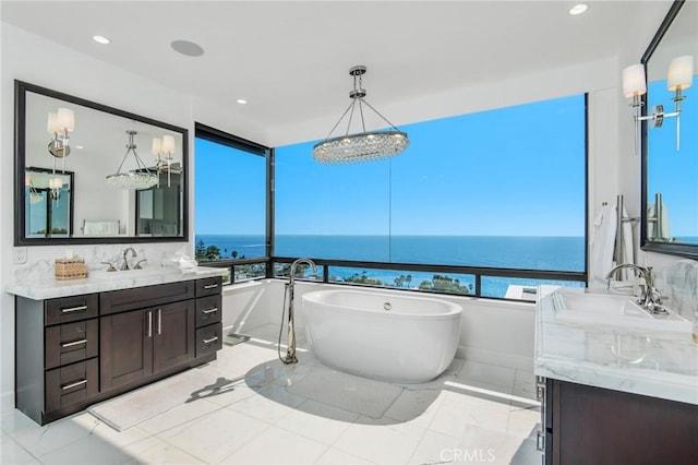 bathroom featuring vanity, a water view, and a wealth of natural light