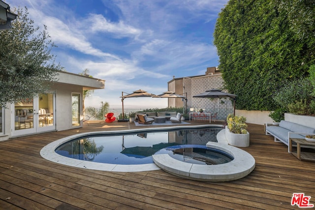 view of swimming pool with outdoor lounge area and a wooden deck