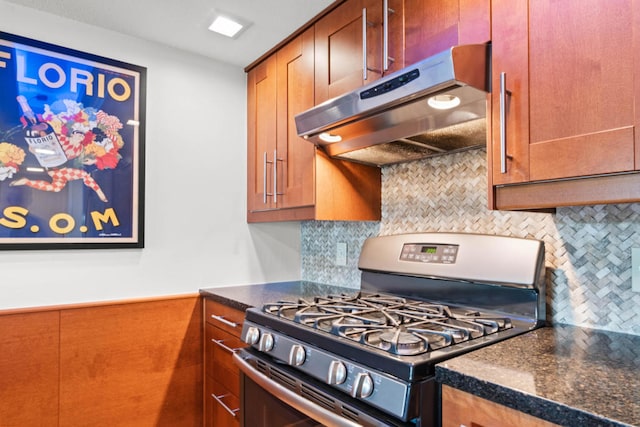 kitchen featuring gas range and decorative backsplash