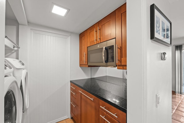 clothes washing area featuring separate washer and dryer and light wood-type flooring