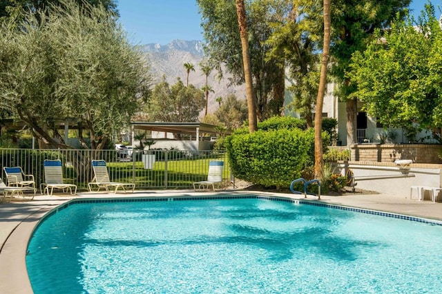 view of swimming pool with a mountain view and a patio area