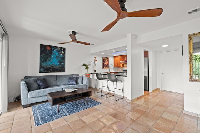 tiled living room with ceiling fan