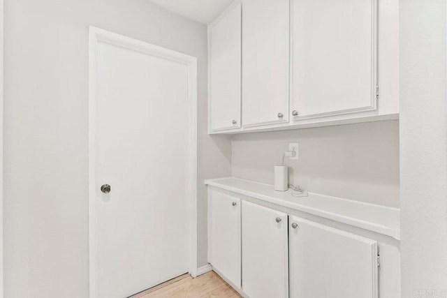 laundry room with light hardwood / wood-style flooring