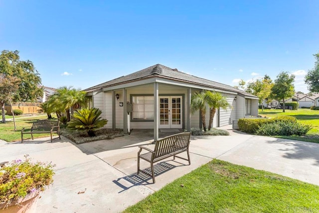 back of house featuring a yard and a garage