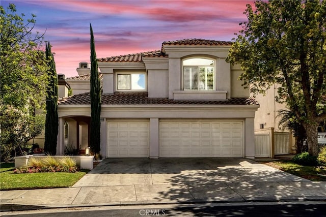 mediterranean / spanish-style home featuring a garage