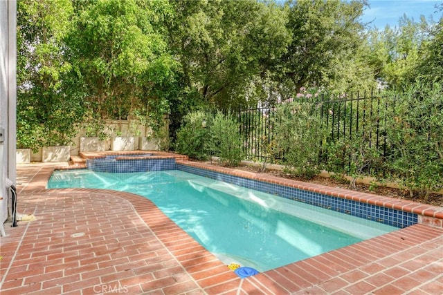 view of swimming pool with an in ground hot tub and a patio area