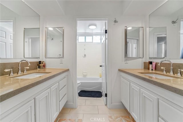 full bathroom with tile patterned floors, vanity, toilet, and tiled shower / bath